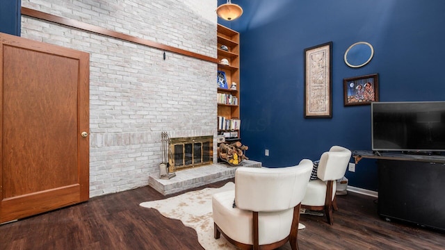 4171 Clotts Rd, Columbus, OH 43230 - living room featuring wood finished floors, a fireplace, baseboards, and brick wall