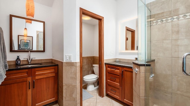 4171 Clotts Rd, Columbus, OH 43230 - bathroom with vanity, a stall shower, toilet, tile walls, and wainscoting