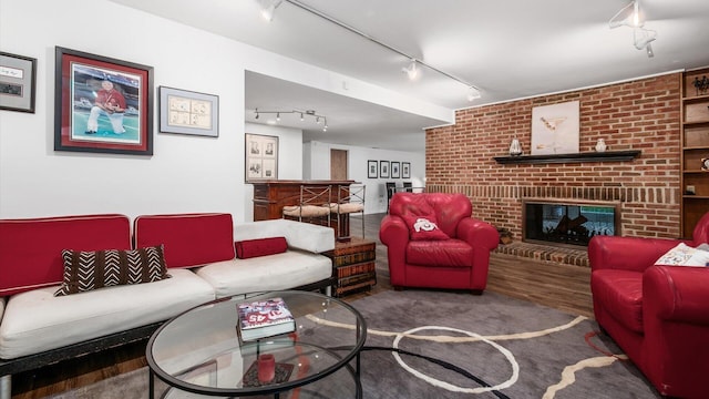 4171 Clotts Rd, Columbus, OH 43230 - living room featuring rail lighting, wood finished floors, and a brick fireplace