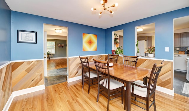 114 Highland Ave, Worthington, OH 43085 - dining space with a chandelier, light wood-style flooring, and baseboards