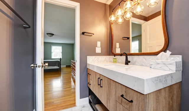 114 Highland Ave, Worthington, OH 43085 - bathroom featuring vanity, baseboards, backsplash, marble look tile flooring, and ensuite bathroom