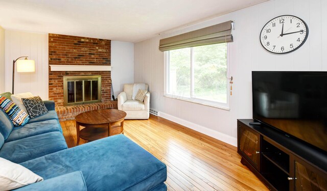 114 Highland Ave, Worthington, OH 43085 - living area with a brick fireplace, light wood-style floors, and baseboards