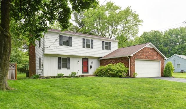 114 Highland Ave, Worthington, OH 43085 - colonial house with board and batten siding, asphalt driveway, a garage, and a front yard
