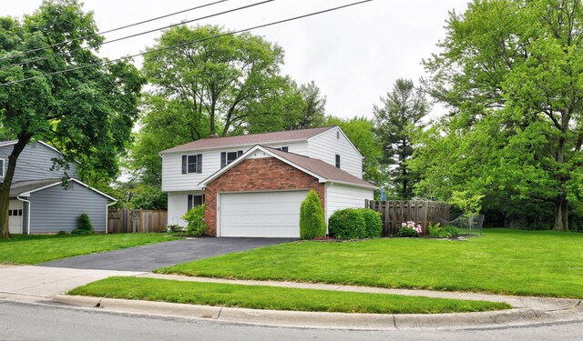 114 Highland Ave, Worthington, OH 43085 - view of front facade featuring brick siding, driveway, and an attached garage