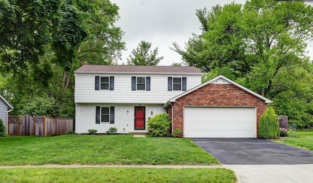 114 Highland Ave, Worthington, OH 43085 - colonial home featuring driveway, a garage, board and batten siding, and brick siding