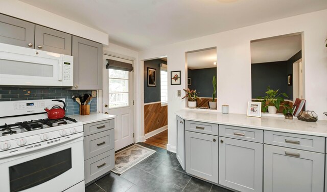 114 Highland Ave, Worthington, OH 43085 - kitchen with white appliances, gray cabinetry, light countertops, backsplash, and dark tile patterned flooring