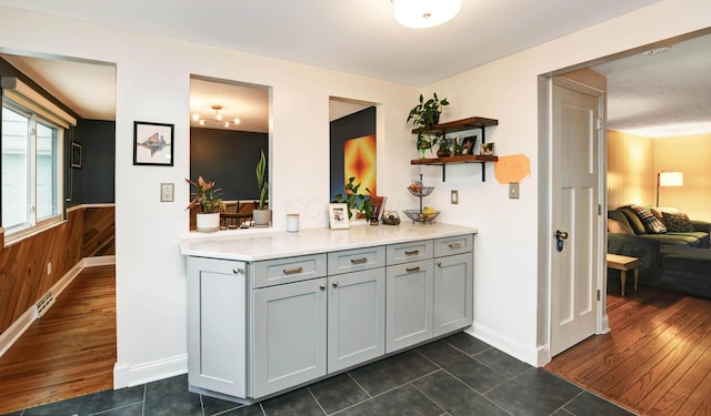 114 Highland Ave, Worthington, OH 43085 - kitchen featuring open shelves, gray cabinetry, dark tile patterned flooring, light countertops, and wainscoting