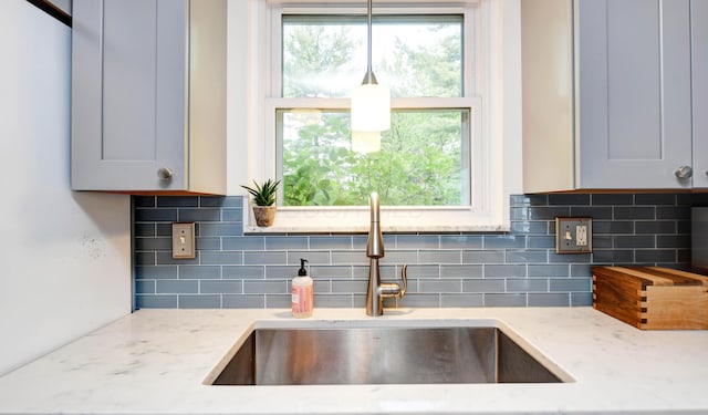 114 Highland Ave, Worthington, OH 43085 - kitchen view of a sink, light stone countertops, decorative backsplash, and gray cabinetry
