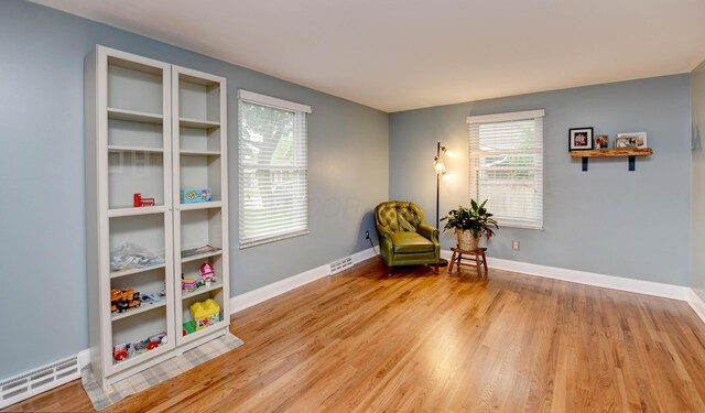 114 Highland Ave, Worthington, OH 43085 - sitting room with baseboards, light wood finished floors, and a baseboard radiator