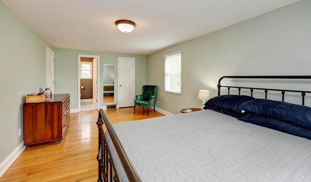 114 Highland Ave, Worthington, OH 43085 - bedroom with light wood-style floors, baseboards, and multiple windows