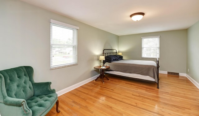 114 Highland Ave, Worthington, OH 43085 - bedroom featuring multiple windows, light wood finished floors, and baseboards