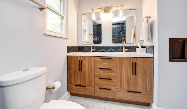 114 Highland Ave, Worthington, OH 43085 - bathroom featuring toilet, double vanity, marble finish floors, and baseboards