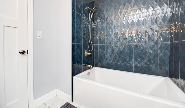 114 Highland Ave, Worthington, OH 43085 - bathroom with baseboards, bathtub / shower combination, and marble look tiles