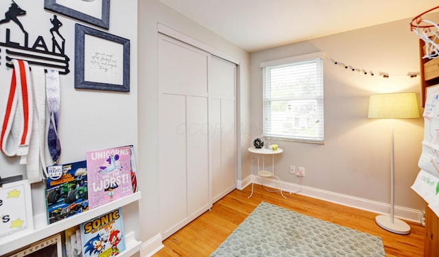 114 Highland Ave, Worthington, OH 43085 - bedroom with light wood finished floors, a closet, and baseboards