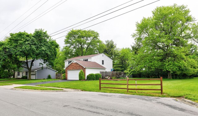 114 Highland Ave, Worthington, OH 43085 - view of front of property featuring an outdoor structure, a garage, and asphalt driveway