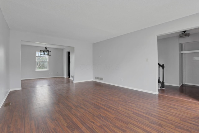 6446 Berry Pond Way, Canal Winchester, OH 43110 - unfurnished living room with stairway, dark wood-style flooring, and baseboards