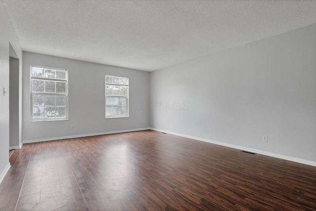 6446 Berry Pond Way, Canal Winchester, OH 43110 - unfurnished room featuring dark wood-type flooring, a textured ceiling, and baseboards
