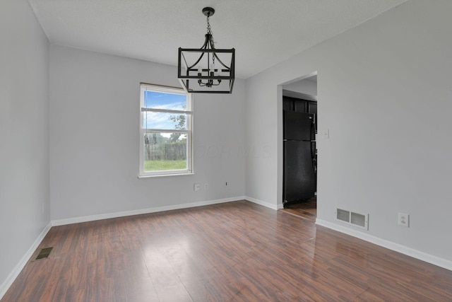 6446 Berry Pond Way, Canal Winchester, OH 43110 - spare room with a chandelier, dark wood finished floors, and baseboards