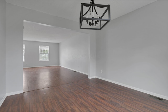 6446 Berry Pond Way, Canal Winchester, OH 43110 - spare room featuring a chandelier, dark wood-type flooring, and baseboards
