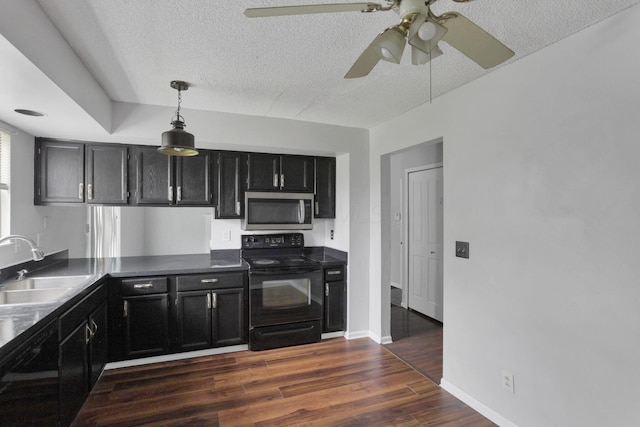 6446 Berry Pond Way, Canal Winchester, OH 43110 - kitchen featuring stainless steel microwave, electric range, dark cabinetry, a sink, and a textured ceiling
