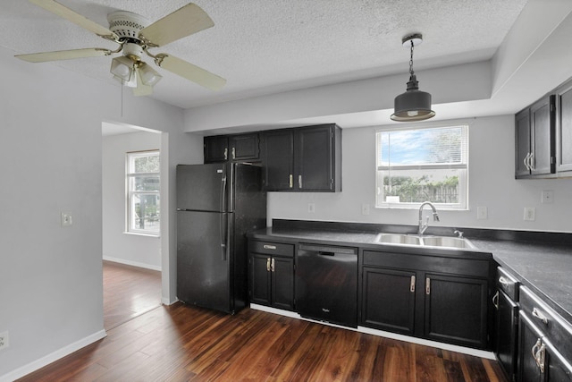 6446 Berry Pond Way, Canal Winchester, OH 43110 - kitchen featuring black appliances, a sink, dark countertops, dark wood-style floors, and decorative light fixtures