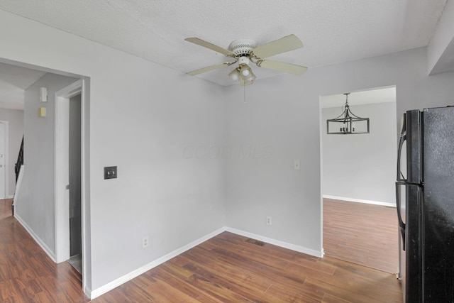 6446 Berry Pond Way, Canal Winchester, OH 43110 - empty room with wood finished floors, ceiling fan, baseboards, and a chandelier