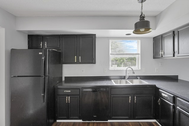 6446 Berry Pond Way, Canal Winchester, OH 43110 - kitchen with black appliances, a sink, dark countertops, hanging light fixtures, and dark wood-style flooring