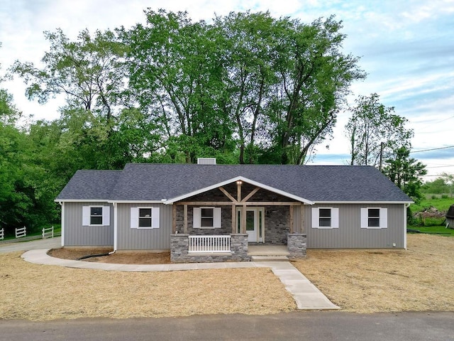 228 E Walnut St, Danville, OH 43014 - view of front of home featuring a porch, a shingled roof, and stone siding