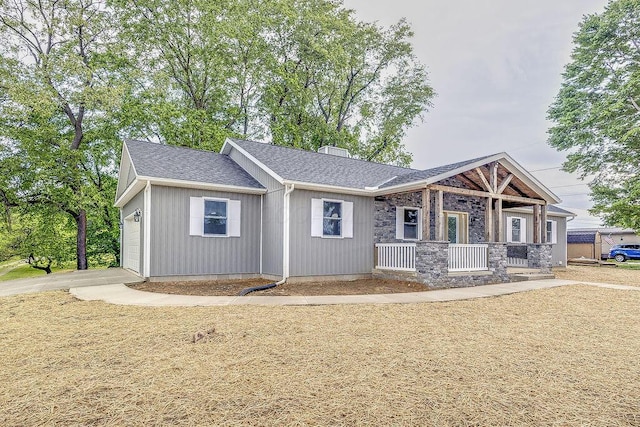 228 E Walnut St, Danville, OH 43014 - view of front of house with covered porch, a chimney, roof with shingles, and stone siding