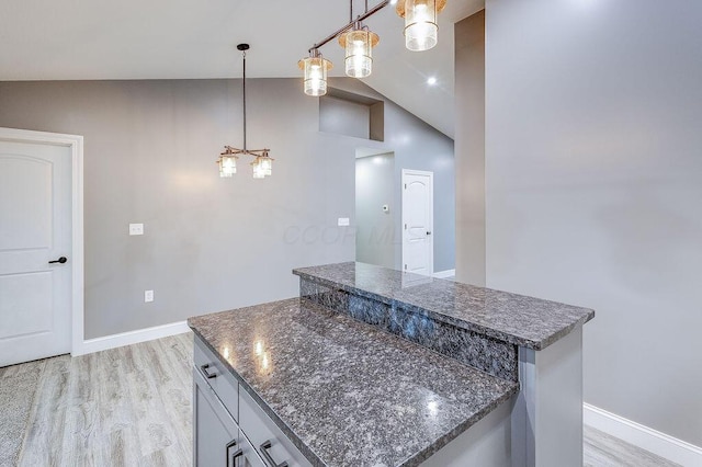 228 E Walnut St, Danville, OH 43014 - kitchen featuring a center island, light wood-style floors, a chandelier, lofted ceiling, and baseboards