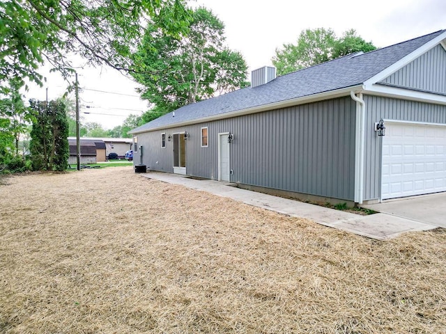 228 E Walnut St, Danville, OH 43014 - back of property featuring a shingled roof and a chimney