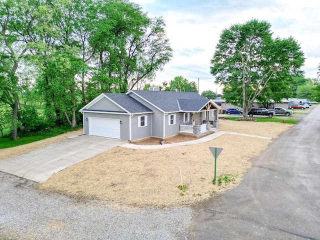 228 E Walnut St, Danville, OH 43014 - ranch-style home featuring covered porch, a garage, roof with shingles, and concrete driveway
