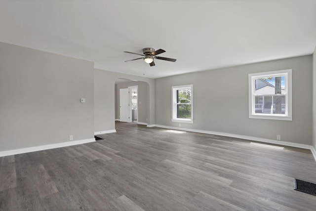 901 E Vine St, Mount Vernon, OH 43050 - unfurnished room featuring ceiling fan, arched walkways, baseboards, and wood finished floors