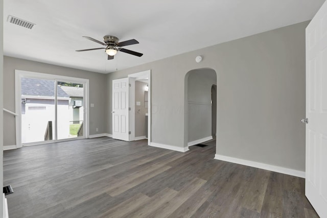 901 E Vine St, Mount Vernon, OH 43050 - spare room featuring a ceiling fan, arched walkways, dark wood-type flooring, and baseboards