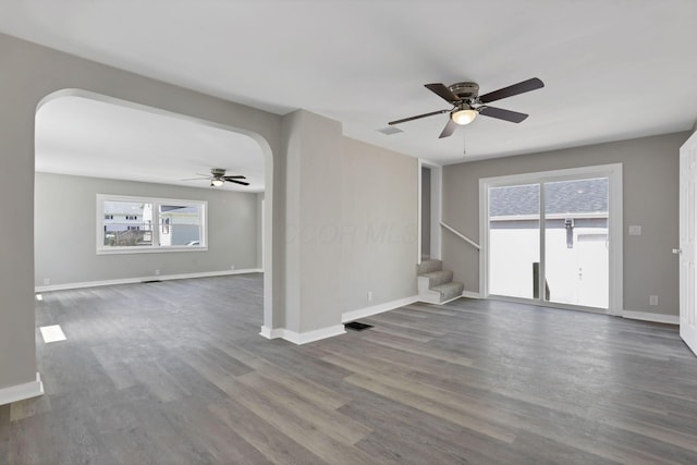 901 E Vine St, Mount Vernon, OH 43050 - unfurnished living room with a ceiling fan, arched walkways, stairs, and wood finished floors