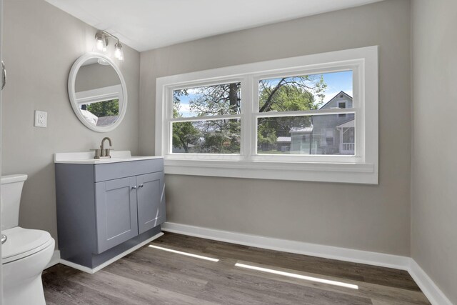 901 E Vine St, Mount Vernon, OH 43050 - half bathroom featuring healthy amount of natural light, wood finished floors, toilet, and baseboards
