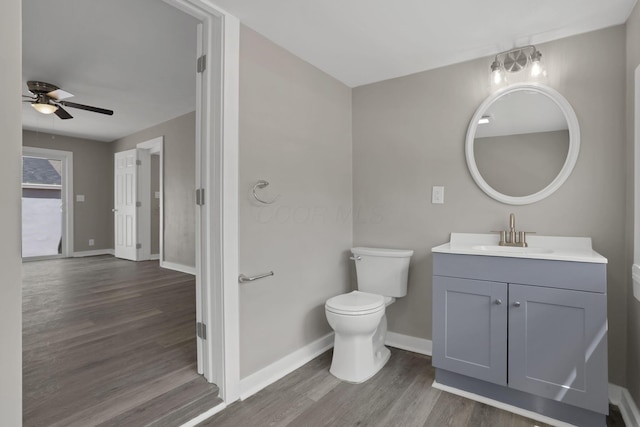 901 E Vine St, Mount Vernon, OH 43050 - bathroom with toilet, ceiling fan, wood finished floors, baseboards, and vanity