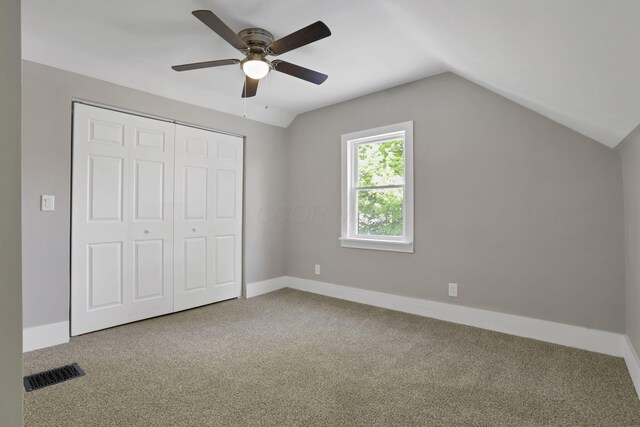901 E Vine St, Mount Vernon, OH 43050 - unfurnished bedroom with carpet floors, vaulted ceiling, a closet, baseboards, and a ceiling fan