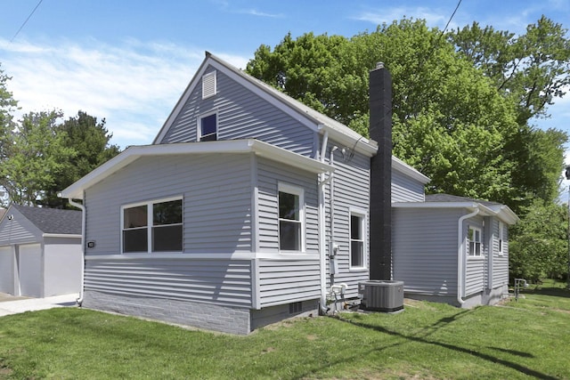 901 E Vine St, Mount Vernon, OH 43050 - view of home's exterior with cooling unit, a yard, a chimney, an outbuilding, and a garage