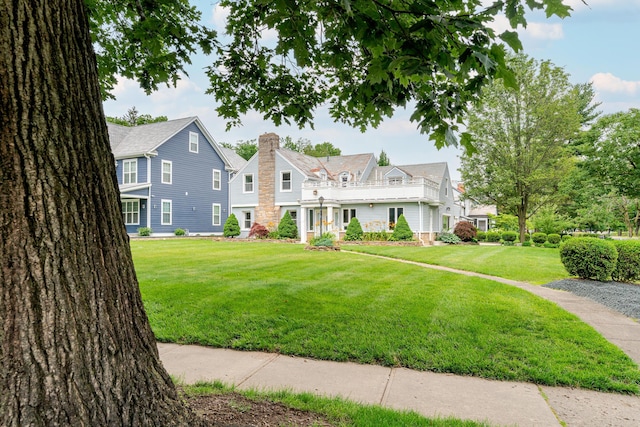 2738 E Broad St, Columbus, OH 43209 - view of front of home with a chimney, a front lawn, and a balcony