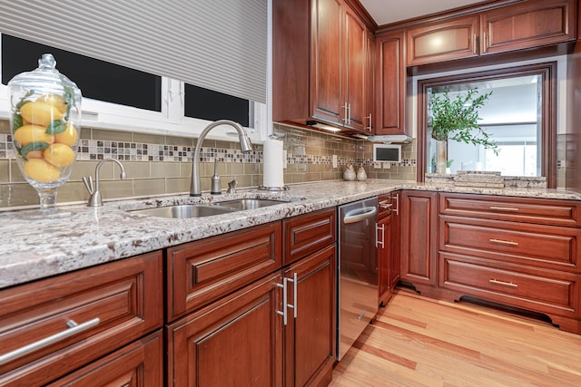 2738 E Broad St, Columbus, OH 43209 - kitchen featuring stainless steel dishwasher, light wood-style floors, decorative backsplash, and light stone counters