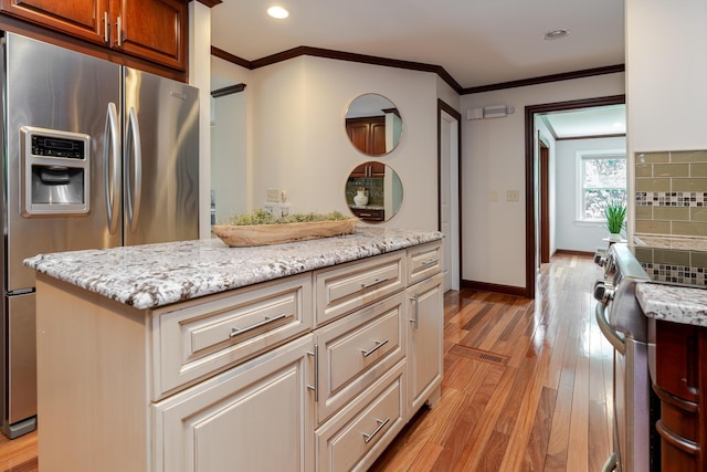 2738 E Broad St, Columbus, OH 43209 - kitchen featuring stainless steel refrigerator with ice dispenser, light wood-style flooring, light stone countertops, decorative backsplash, and crown molding