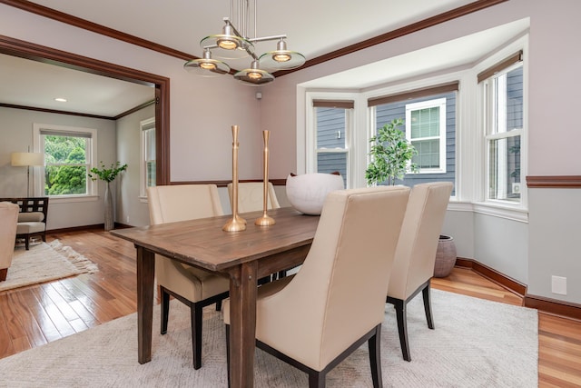 2738 E Broad St, Columbus, OH 43209 - dining room featuring crown molding, light wood-style floors, and a chandelier