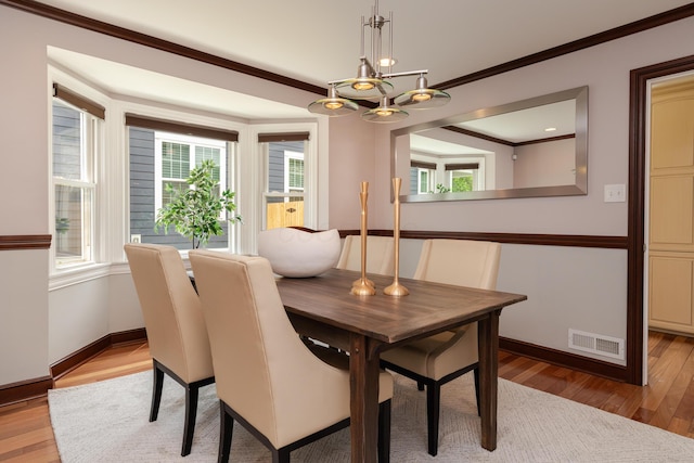 2738 E Broad St, Columbus, OH 43209 - dining area with a chandelier, crown molding, and light wood finished floors