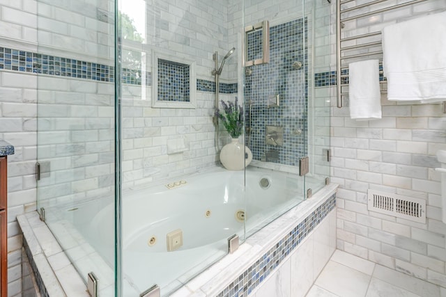 2738 E Broad St, Columbus, OH 43209 - bathroom with a combined bath / shower with jetted tub, a towel warming rack, and tile walls
