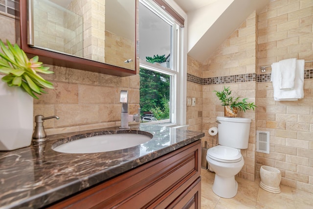 2738 E Broad St, Columbus, OH 43209 - bathroom with tile walls, vanity, and tile patterned floors