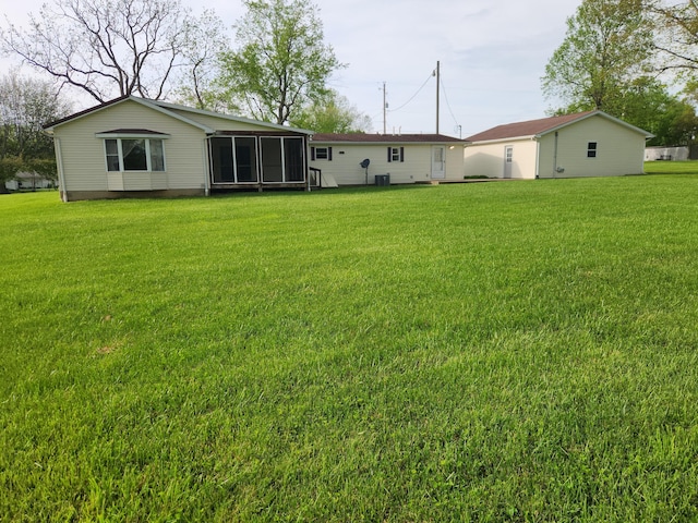 5747 E Clinton St, Albany, OH 45710 - back of property featuring a sunroom and a lawn