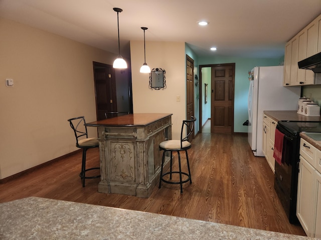 5747 E Clinton St, Albany, OH 45710 - kitchen featuring black electric range, dark wood-type flooring, white cabinetry, a kitchen bar, and recessed lighting