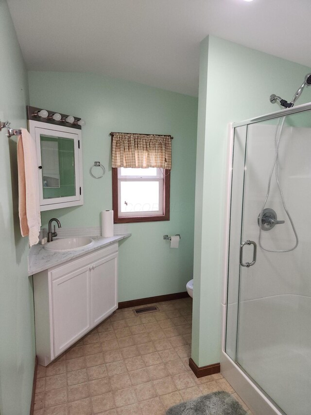 5747 E Clinton St, Albany, OH 45710 - full bathroom featuring a stall shower, vanity, toilet, and baseboards