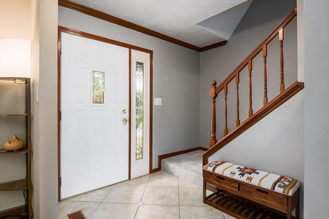 2862 Shady Ridge Dr, Columbus, OH 43231 - foyer featuring stairway, a textured ceiling, light tile patterned floors, crown molding, and baseboards